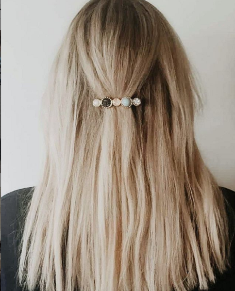 Sleek hairstyle with simple pin accessory