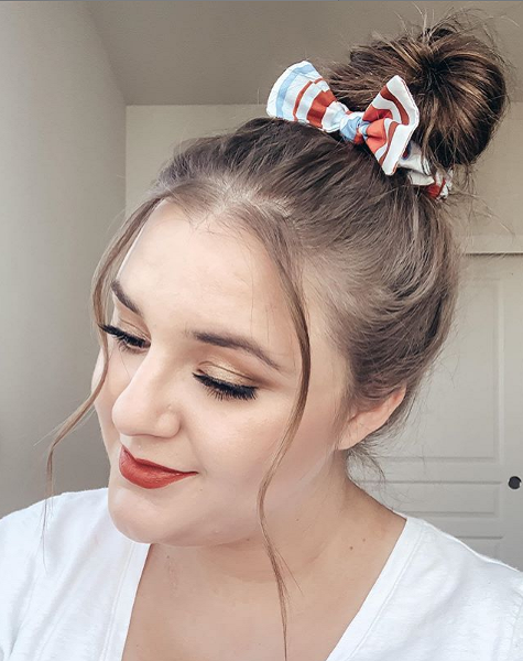Top knot with bow and face-framing strands