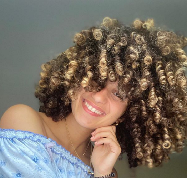Medium Curly Hairstyle with Bold Curly Bangs for Thick Hair
