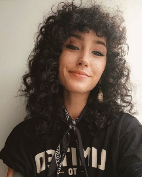 Medium Curly ‘70s Retro Hairstyle with Messy Curly Bangs