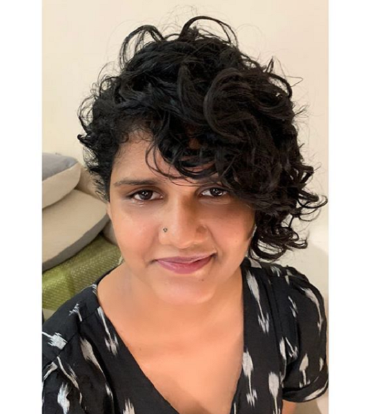 Asymmetrical Curly Pixie with Side-Parted Long Bangs