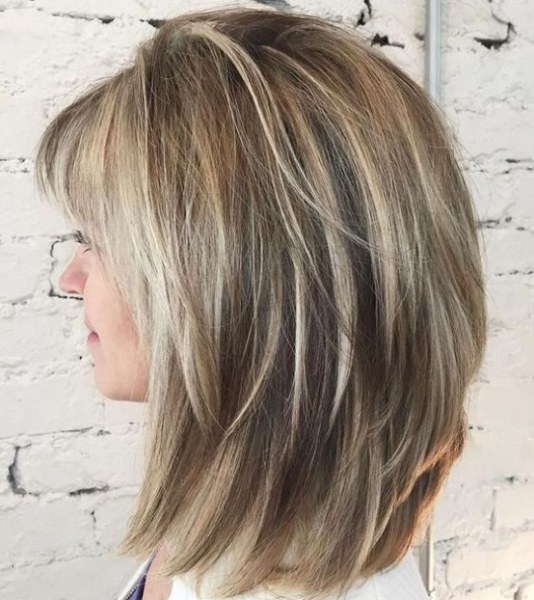 Straight Medium-Length Layered Blonde Hairstyle with Blunt Bangs