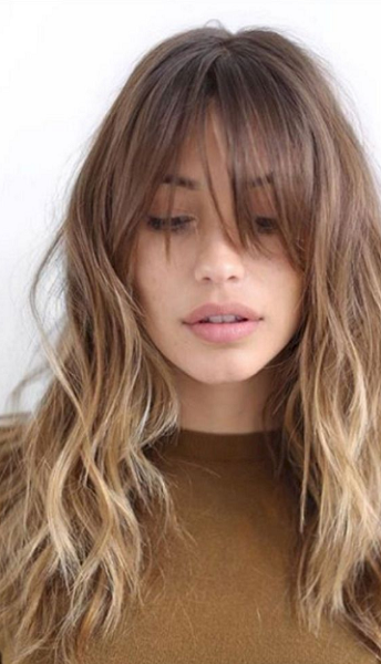 Wavy Medium-Length Layered Hairstyle with Long Blunt Bangs