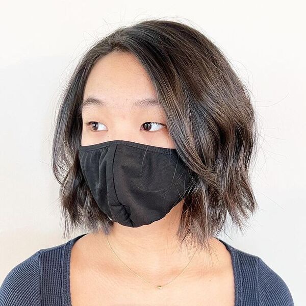 Boho Curl Bob Cut- a woman wearing a black facemask.