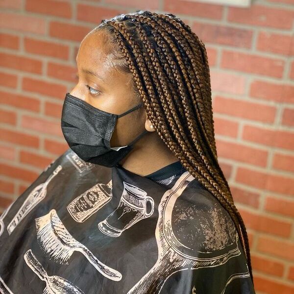 Choco Knots Braid Hairstyles- a woman wearing a black facemask.
