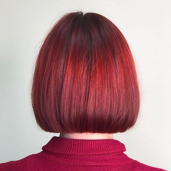 Cropped Bob Haircut- a woman wearing a red shirt.