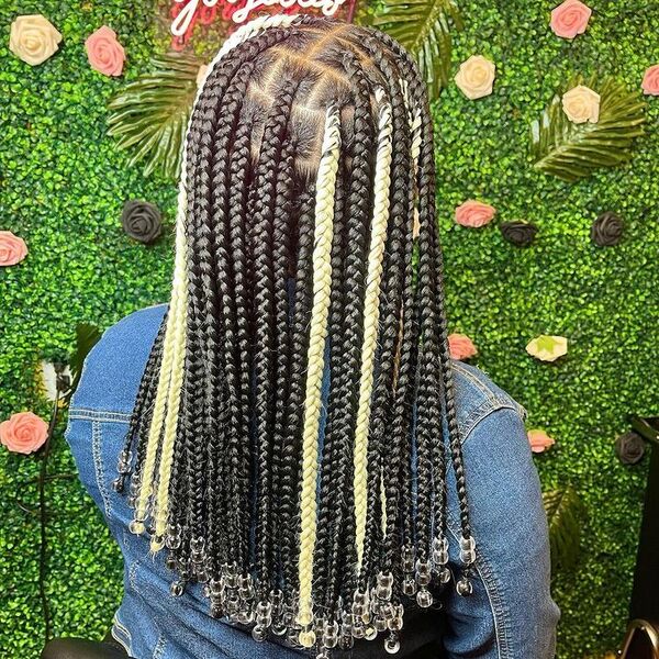 Goddess Locs Braids Hairstyles- a woman with a floral background.