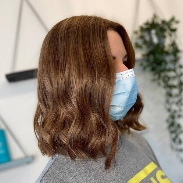 New-Wave Bob Cut- a woman wearing a surgical facemask.
