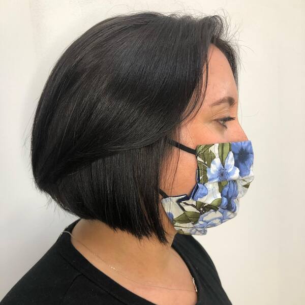 Radiant Black Blunt Bob- a lady wearing a floral facemask.