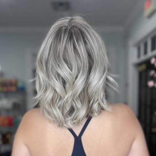 Shimmery Shade Platinum Blonde Hairstyles - a woman wearing a dark blue top.