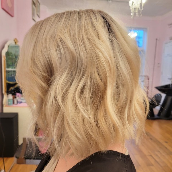 Short Inverted Bob Blonde Style - a lady wearing a black shirt.