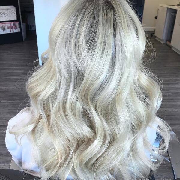 Soft Waves Silvery Blonde Style - a woman wearing a white shirt.