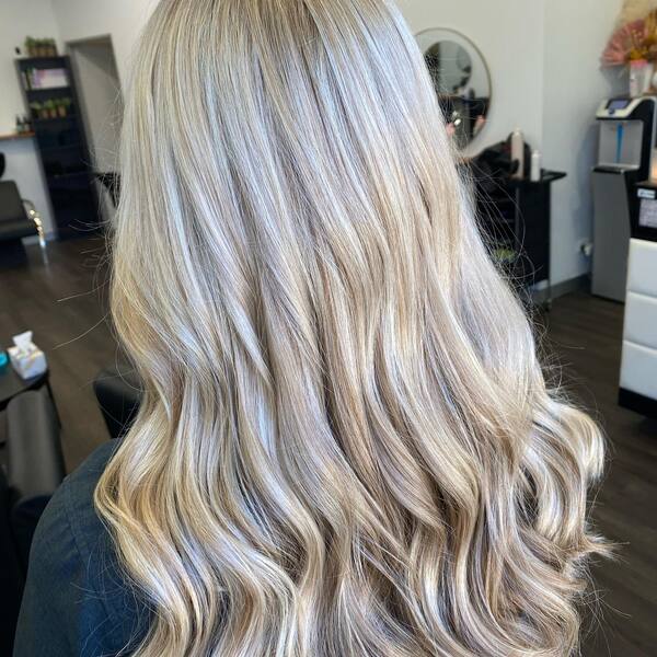 Tousled Waves Platinum Blonde Hairstyles - a woman inside a room.