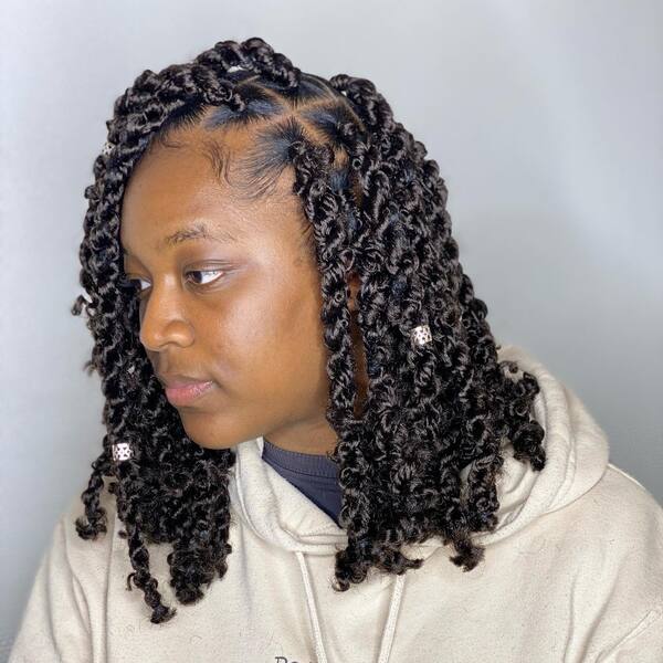 Short Twist Hairstyle with Beads - a woman wearing a cream hooded jacket
