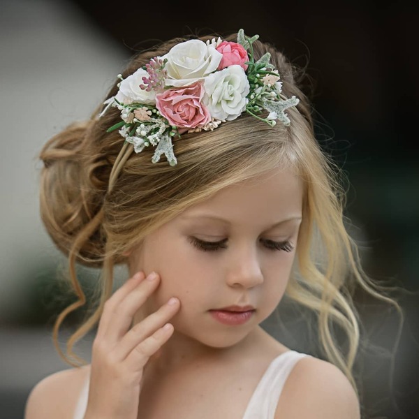 Messy Look with Flower Pins - a woman wearing a white sleeveless dress